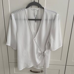 White BCBG cross over top with sleeves perfect for work or play